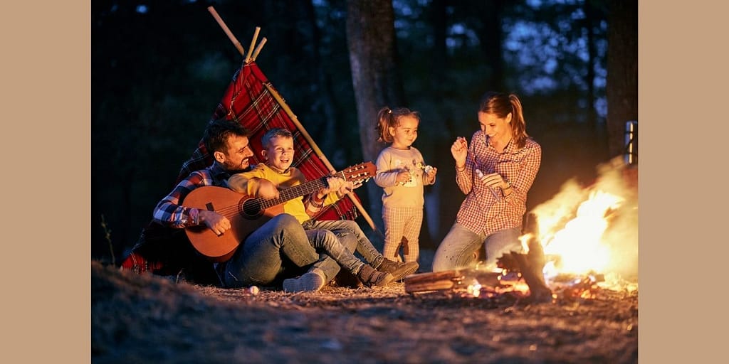 Family having a nurturing camping trip by the fire.