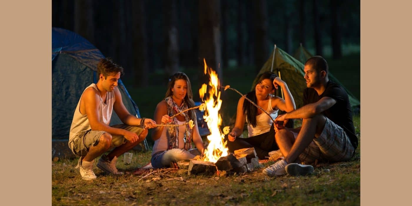 Family camping by the fire.